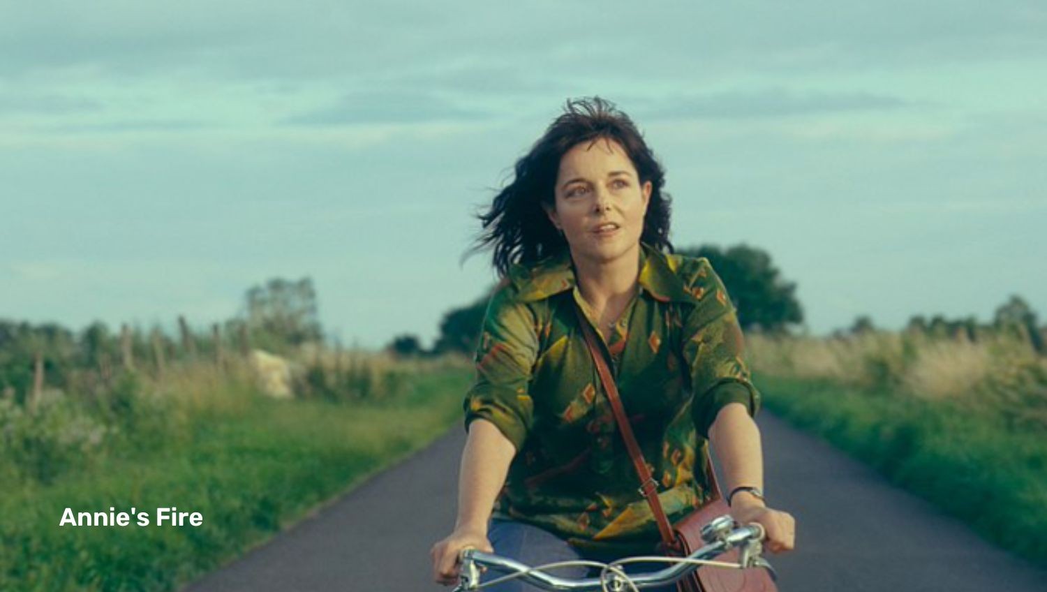 Woman on bike on country road