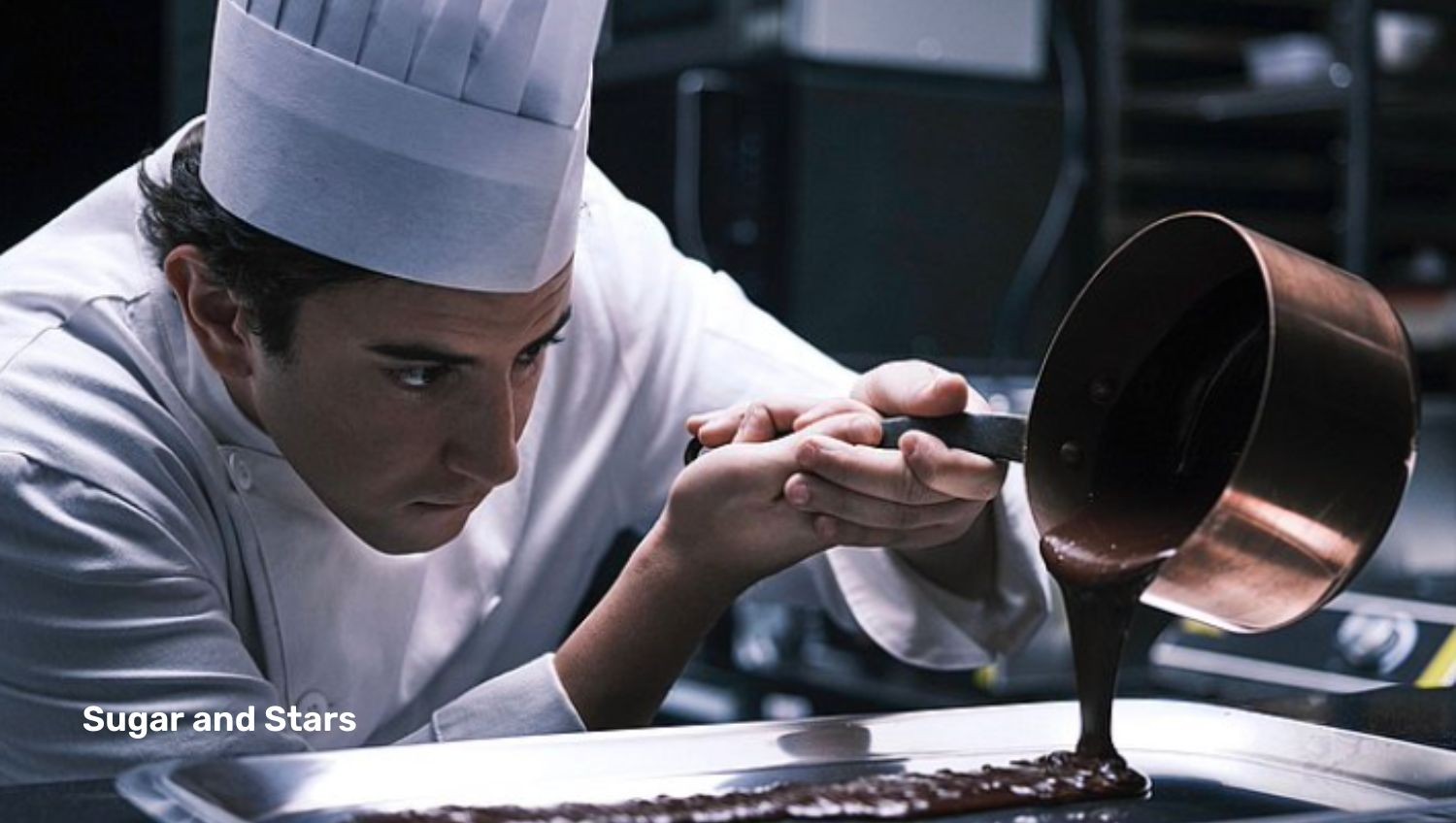 Chef pouring chocolate onto tray