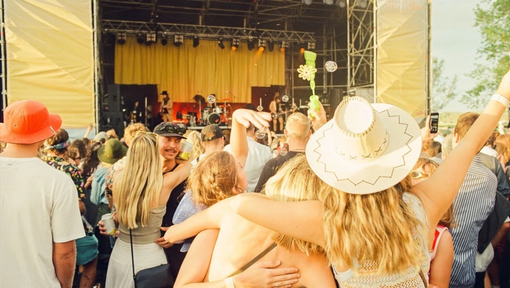 People dancing in front of outside stage