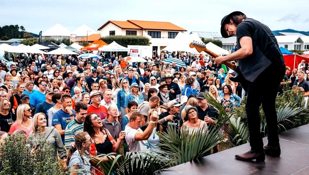 Crowd at A Taste of Matarangi festival watching guitarist