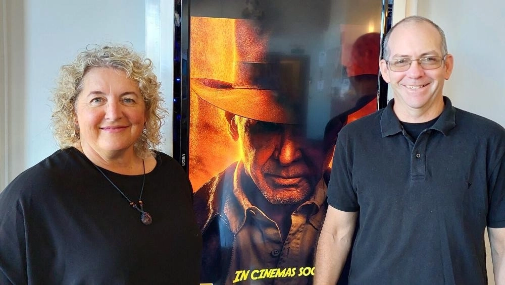 Anne-Maree &amp; Matt standing in front of poster