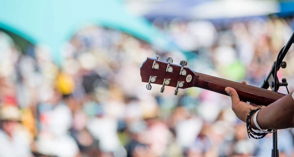 Guitar with blurred shot of crowd behind