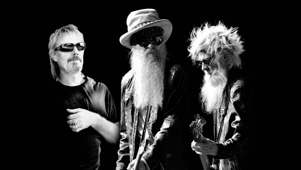 Three &#039;Sharp Dressed Men&#039; on stage at 2023 Whitianga Summer Concert