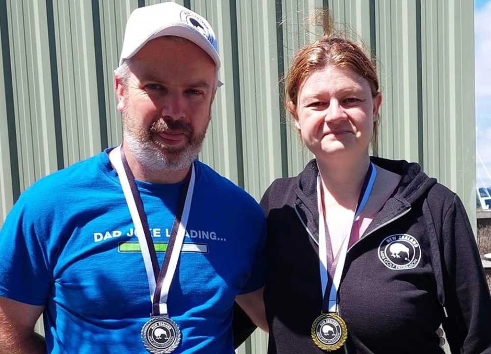 Man and woman wearing medals