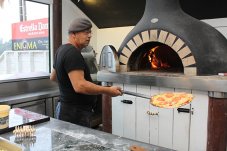 Mans cooking Pizzas at Enigma on The Esplanade