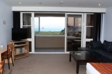 Views out to closed deck area Admiralty Lodge Whitianga