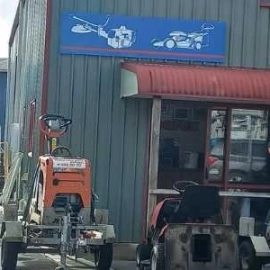 Front yard of commercial hire shop diggers and machinery