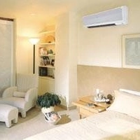 Bedroom with heat pump on wall