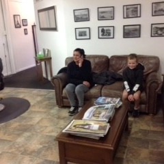 women and boy sitting on couch