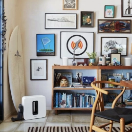 Chair, bookcase and paintings on wall