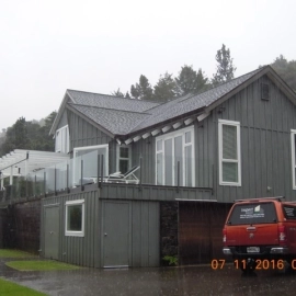 Grey house with vehicle parked out side