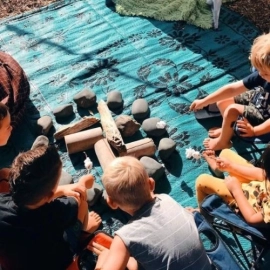 Children playing with rocks on mat