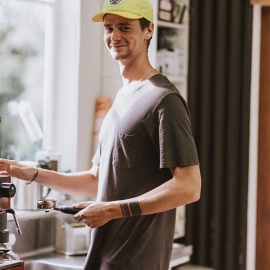 Man smiling in yellow cap