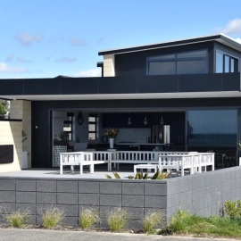 Beach house with outdoor fireplace in patio area