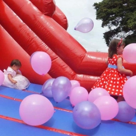 Pink balloons on bouncy castle