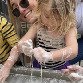 small girl with goop on hands