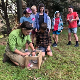 Woman showing children rat trap