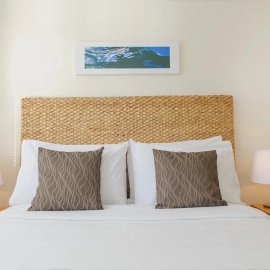 Bed with taupe cushions