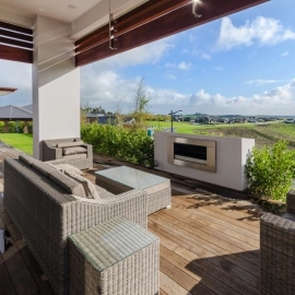 Outdoor fireplace and timber deck looking out to rural views