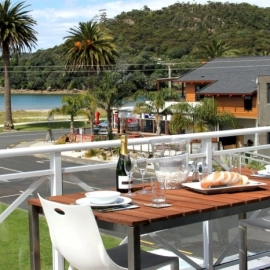 Outside table and chairs on deck overlooking beach