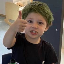 Small boy with thumb up