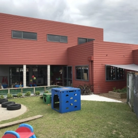 Red building with blue play equipment