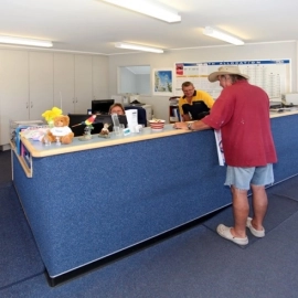 Man in red shirt standing at desk