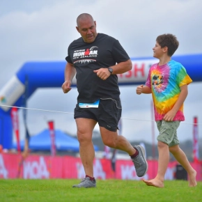 Man and bot crossing finish line