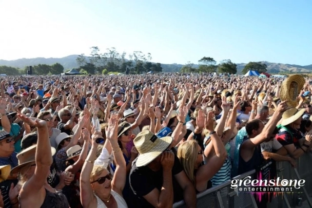 Crowd at concert with hands in air